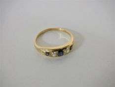 An 18ct gold diamond and sapphire ring, size L, 2.5g.