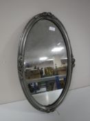 A pine wall shelf, together with an oval silvered framed mirror,