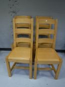 A set of four pine high backed dining chairs