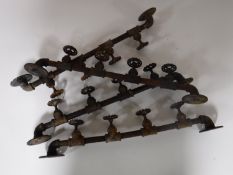 Four cast iron coat racks in the form of plumbing valves