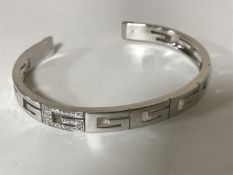 An 18ct gold diamond set bangle by Gucci, 28.