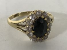 An 18ct gold diamond sapphire cluster ring, size L/M.