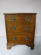 An inlaid mahogany storage box in the form of a Victorian three drawer chest CONDITION