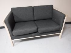A contemporary pine framed two seater settee