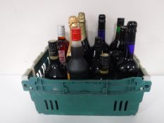 A crate containing twelve bottle of alcohol, including port, Harveys Bristol Cream, Baileys,