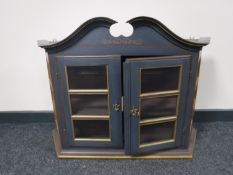 A painted hanging wall cabinet