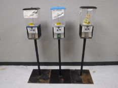 Three American North Western gumball dispensers on stands
