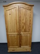 A contemporary pine double door wardrobe fitted a drawer