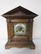 An early twentieth century carved oak cased bracket clock