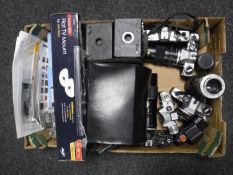 A box containing assorted cameras, including Olympus OM10, Zenit E, etc, together with lenses,