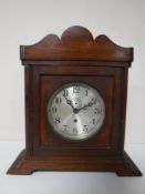 A brass cased American ship's clock with silvered dial,