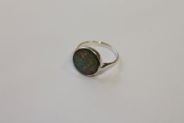 An opal ring set in white metal, size P.