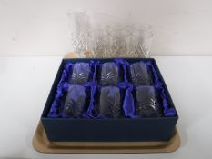 A tray containing a set of six boxed Bohemian Crystal whiskey tumblers,
