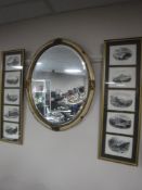 A cream and gilt oval framed bevel edged mirror, together with two gilt,