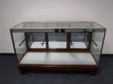 An early twentieth century brass framed shop display cabinet