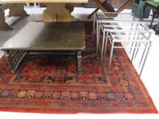 An Oriental style low coffee table on bamboo legs,