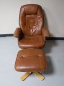 A tan leather swivel relaxer chair with matching stool