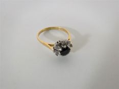 An 18ct gold diamond and sapphire cluster ring CONDITION REPORT: Size O.