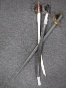 Two Indian swords together with a wooden practice sword