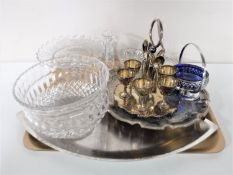 A tray containing lead crystal and cut glass pieces, plated egg cups and spoons on stands,