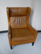 A mid twentieth century Danish tan leather wingback armchair