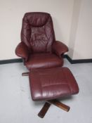 A burgundy leather swivel relaxer chair with matching stool