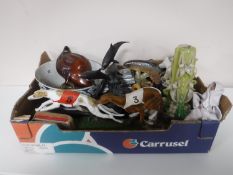 A box containing an antique blue and white glazed fruit bowl, metal figure dolphins,