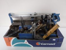 A box containing two Mitre saws,