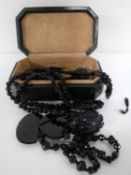 A collection of Whitby Jet jewellery - buckle, necklaces etc.