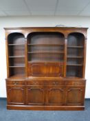 A mahogany Regency style bookcase fitted cupboards and drawers beneath