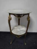 A marble and gilt circular two tier plant stand