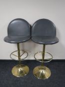 A pair of leather upholstered bar stools on chrome bases