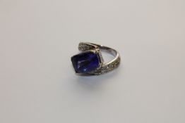 A 14ct gold tanzanite ring set with diamond shoulders, 7.3g, size J.