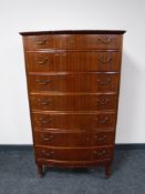 A mid twentieth century mahogany bow fronted seven drawer chest