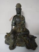 A Chinese bronze figure of a deity seated on an elephant