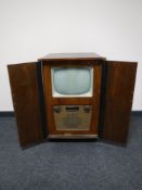 A mid twentieth century walnut cased Ekco television in cabinet