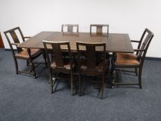 An eight piece early twentieth century oak dining room suite, comprising of cocktail sideboard,
