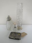 A silver cigarette case, a silver topped cut glass bottle,