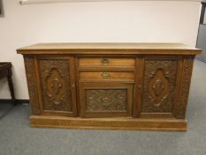 A Victorian carved oak sideboard,