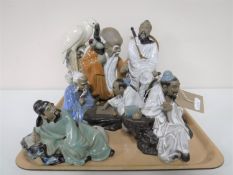 A tray containing eight Japanese pottery figures