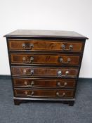 An inlaid mahogany five drawer chest