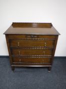 An early twentieth century oak three drawer chest