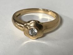 An 18ct gold ring set with a .15 solitaire diamond, 4.