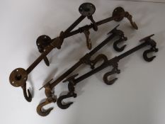 Four cast iron butchers hook coat racks