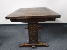 An oak Arts and Crafts pull out dining table