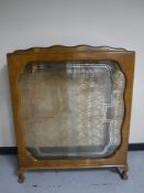 A mid twentieth century walnut display cabinet on claw and ball feet