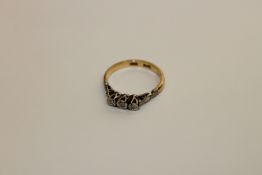 An 18ct gold three stone diamond ring