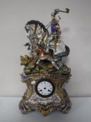 An antique gilded china mantel clock, depicting two knights in battle, with enamelled dial,