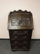 A late Victorian Green Man carved oak bureau,