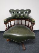 A green button leather swivel captains armchair